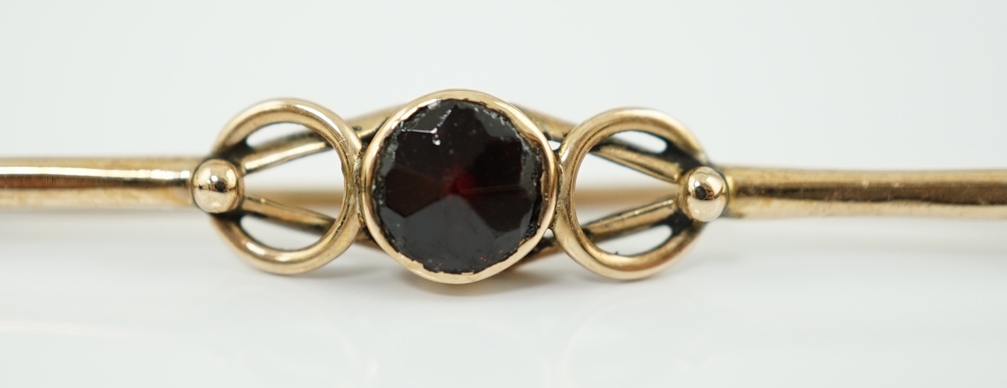 A late 19th century Russian August Wilhelm Holstrom for Faberge 56 zolotnik gold and single stone garnet set bar brooch